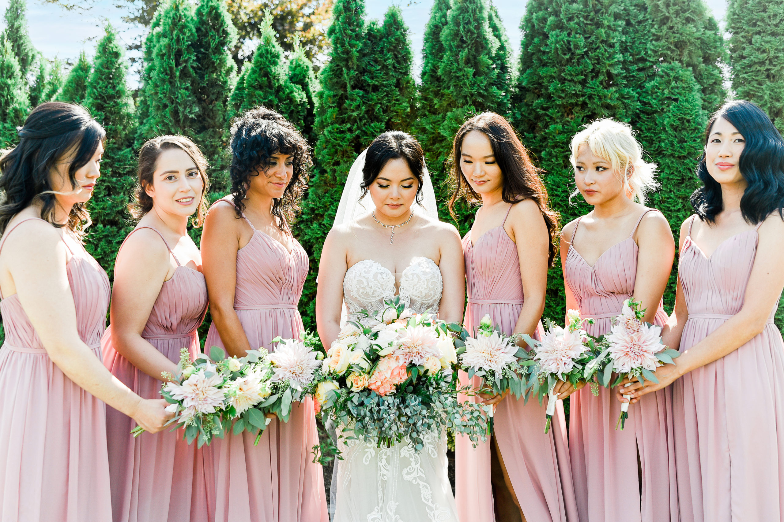 Bridesmaids posing with bouquets at Lord Hills Farms Wedding Venue in Seattle, Washington.