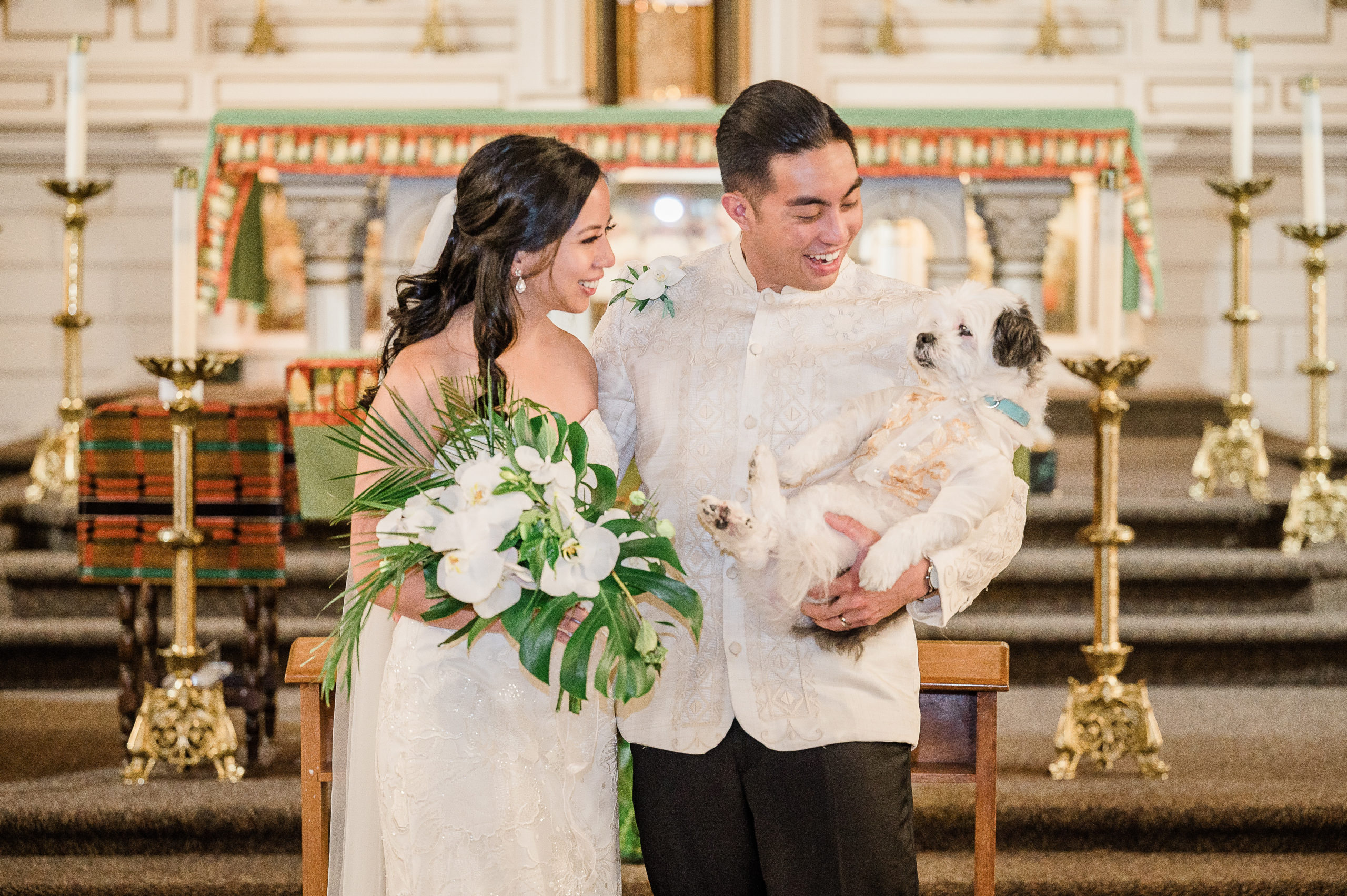 Couple holding their adorable dog at the altar after getting married. This was at the Immaculate Conception Church in Seattle, Washington.