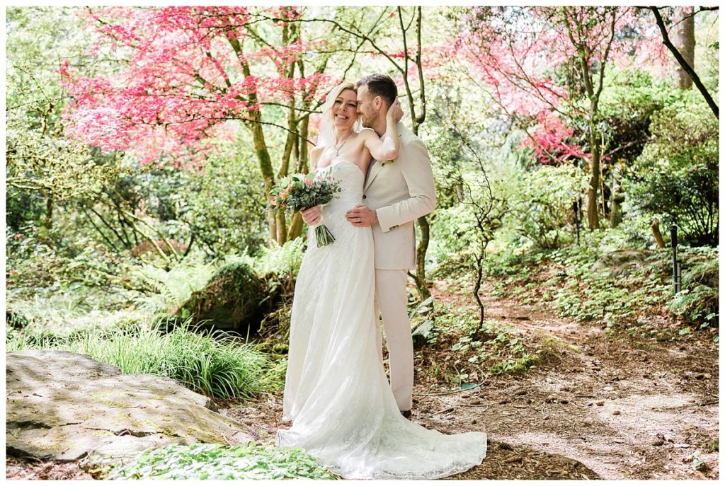 Couple posing in Seattle Garden after Wedding.