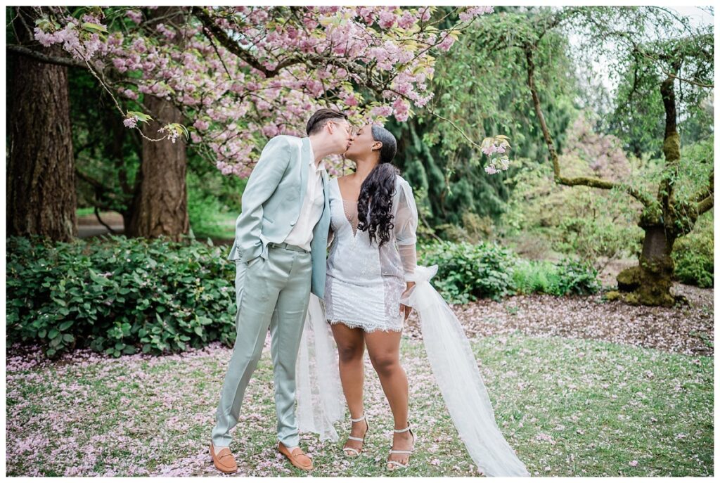 LGBTQ+ interracial couple kissing under the tree during their Seattle engagement photography session.
